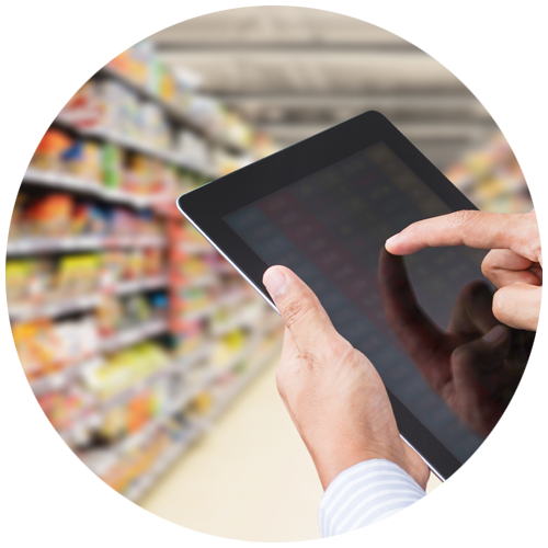 Circle with a hand holding a tablet with grocery store aisle in background